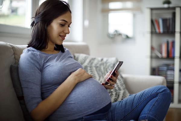 Young pregnant woman on cell phone